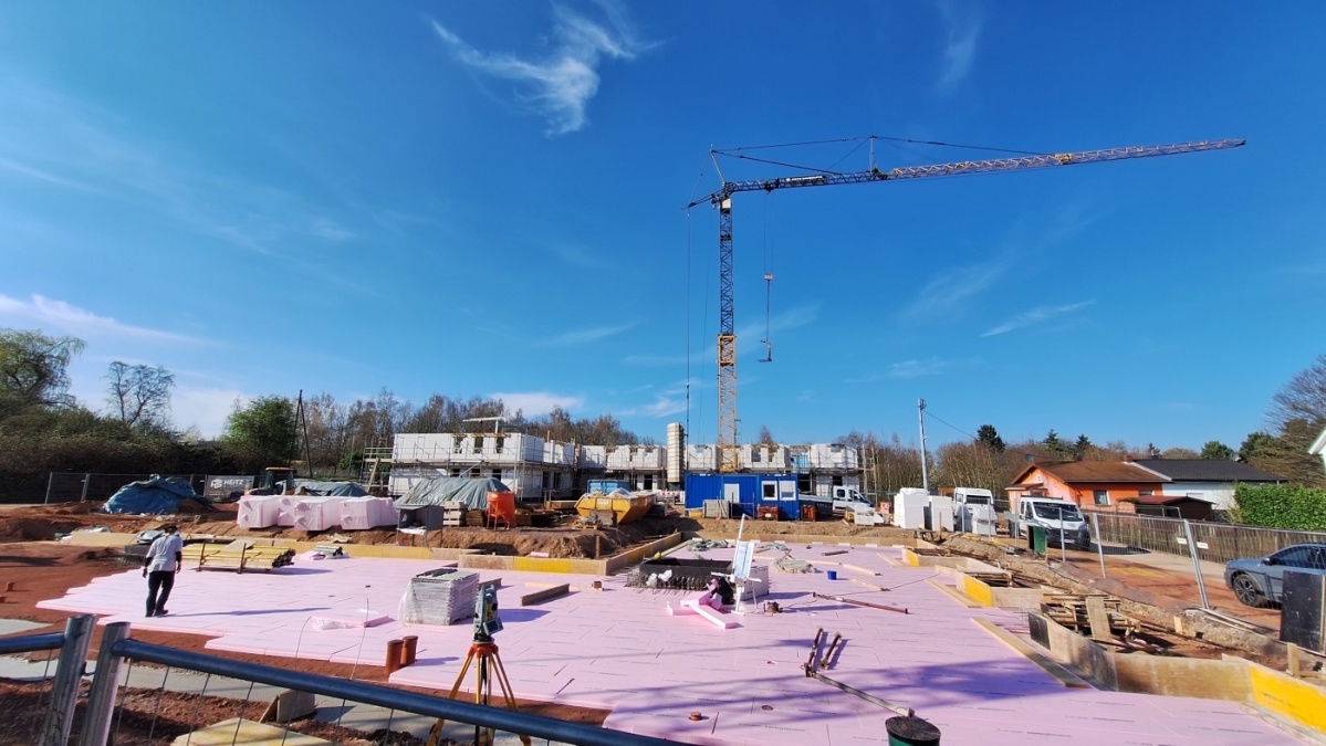 Vorne Bodenplatte 2. Gebäude, hinten Baukran.